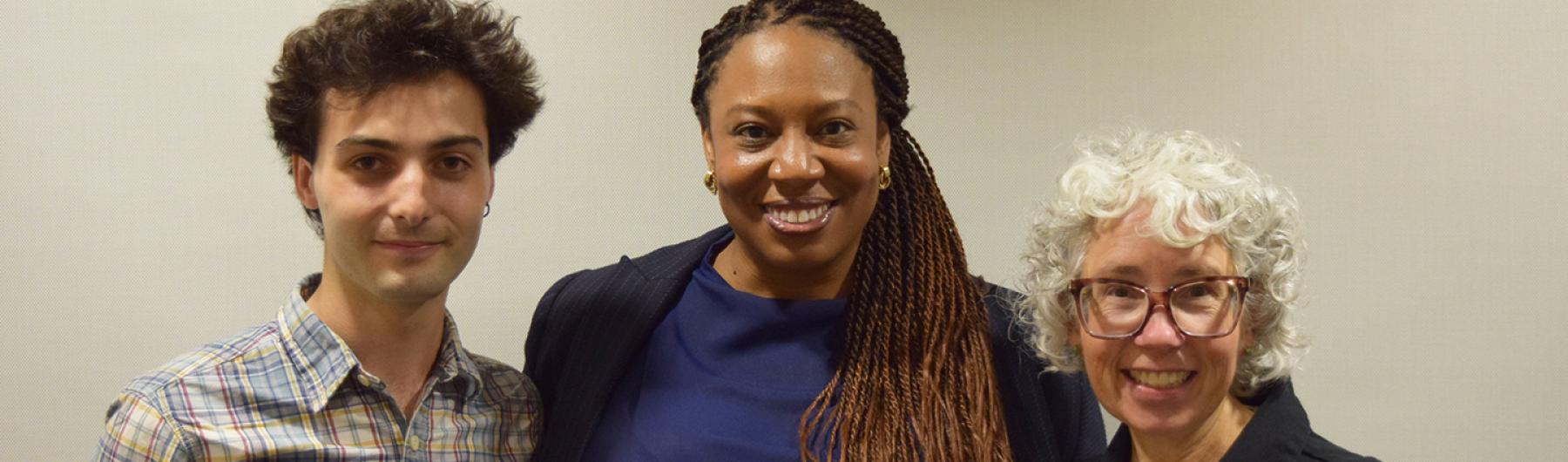 Three poeple smiling at the camera.